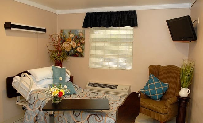 Cozy resident room with floral decor and amenities