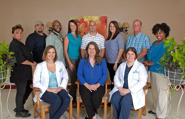 Staff posing together in a facility common area