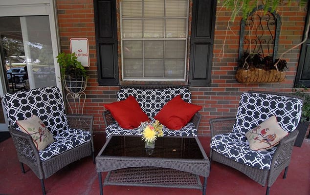 Outdoor seating area with patterned furniture and flowers