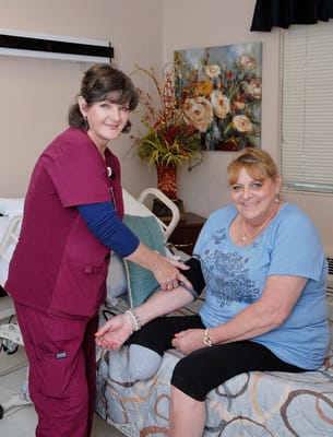 Nurse assisting a resident in a private room