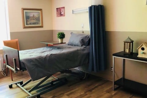 A furnished resident room with a bed and decor