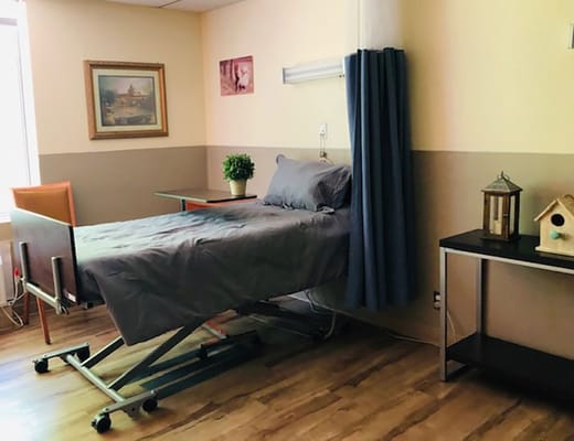 A private resident room with a hospital bed