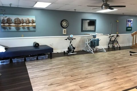 Well-equipped rehabilitation therapy room with exercise equipment