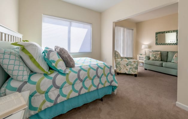 Cozy resident room with a bed and seating area