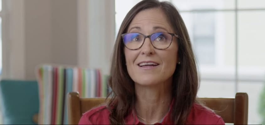A staff member speaking in an indoor setting