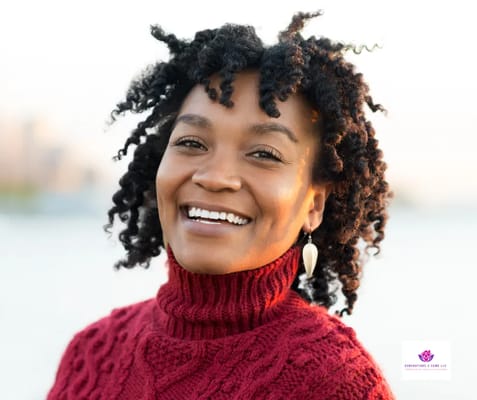 Smiling woman in a red sweater outdoors