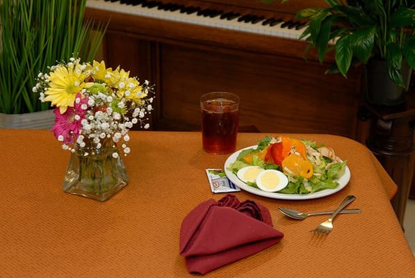 A well-presented meal on a table with flowers