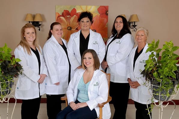 Staff members posing in a bright interior setting