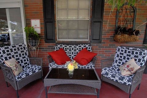 Cozy outdoor seating area with cushions and flowers