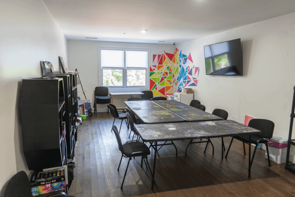 Bright activity room with tables and chairs