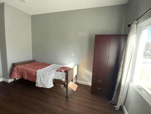 Cozy resident room with a bed and dresser