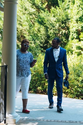 Two individuals walking in a garden area