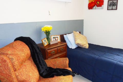 Cozy resident room with floral decorations and a chair