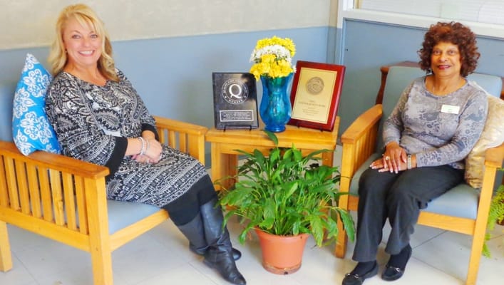 Two staff members sitting in a welcoming lounge area