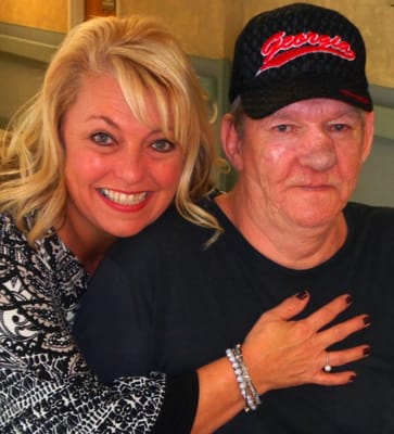 A resident enjoying time with a staff member at the facility