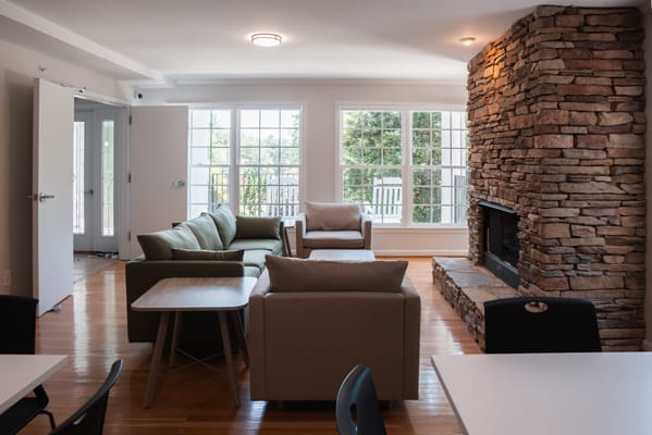 Cozy lounge area with a stone fireplace and seating