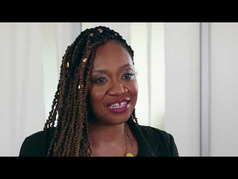 A resident sitting on a couch in a cozy room