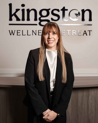 Staff member posing in front of the reception area