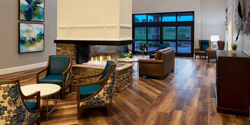 Modern lobby area with a fireplace and seating