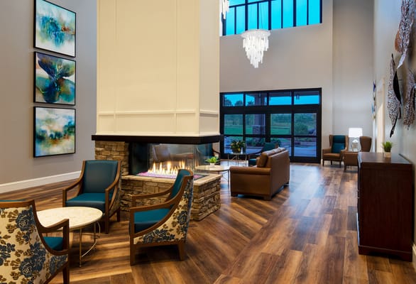 Bright and inviting facility lobby with seating and fireplace