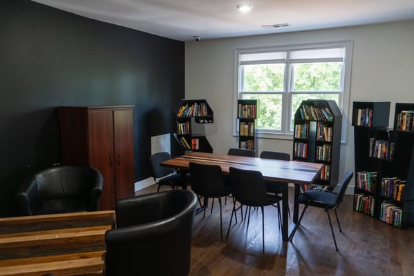 A cozy common area with bookshelves and seating
