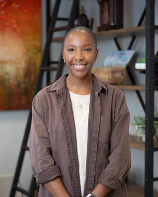 Staff member smiling in a welcoming interior space