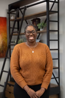 Smiling staff member in a warm interior setting