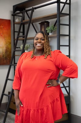Staff member smiling in a bright interior space