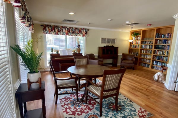 Common area with seating and bookshelves in a cozy setting