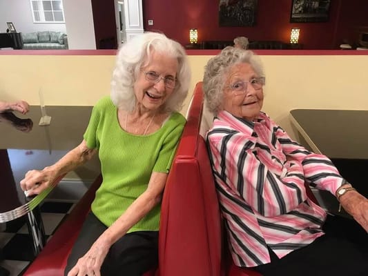 Two residents smiling in a cozy setting