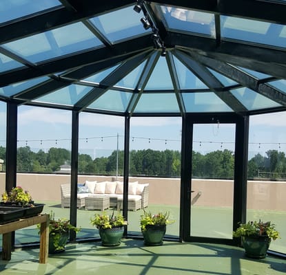 A sunlit indoor space with seating and plants