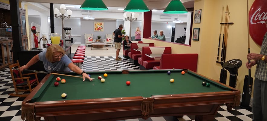Residents enjoying a game of pool in the activity room