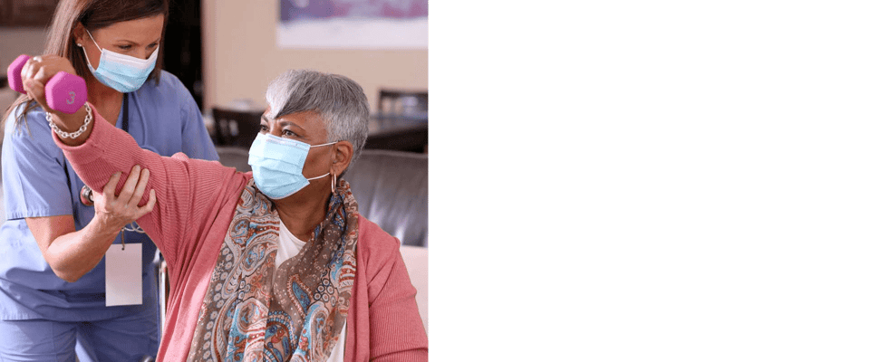 A staff member assisting a resident with exercises