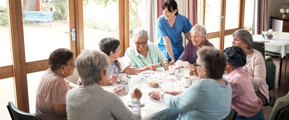 Residents engaging in a card game in a common area