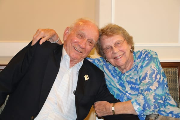 Two residents smiling together in a common area