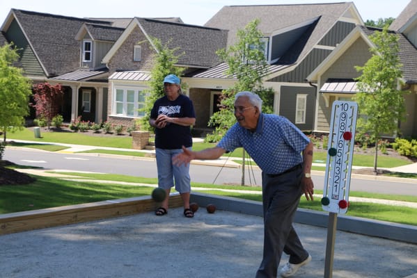 Residents playing bocce ball in a community space