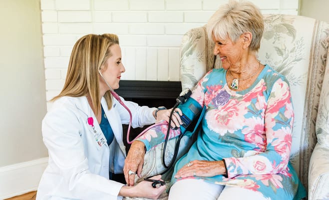 Nurse checking the blood pressure of an elderly woman