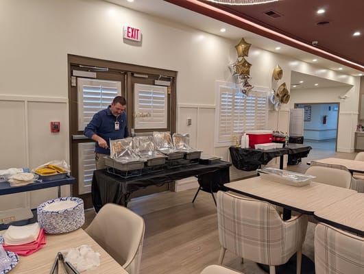 Staff serving food in a dining area with decor