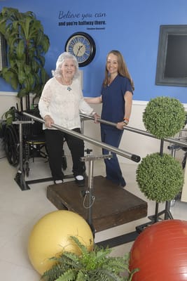 Staff assisting a resident in a therapy session