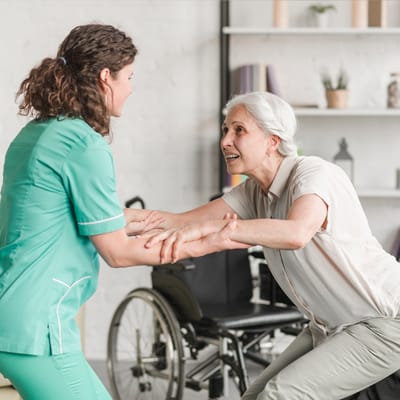 Staff assisting resident in an indoor activity