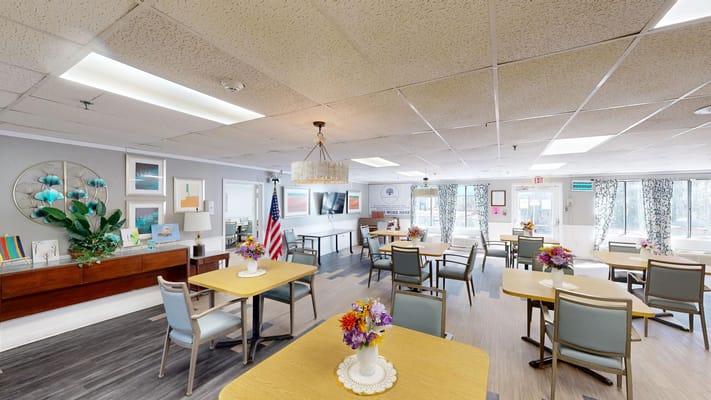 Dining area with tables and flowers, American flag in the background