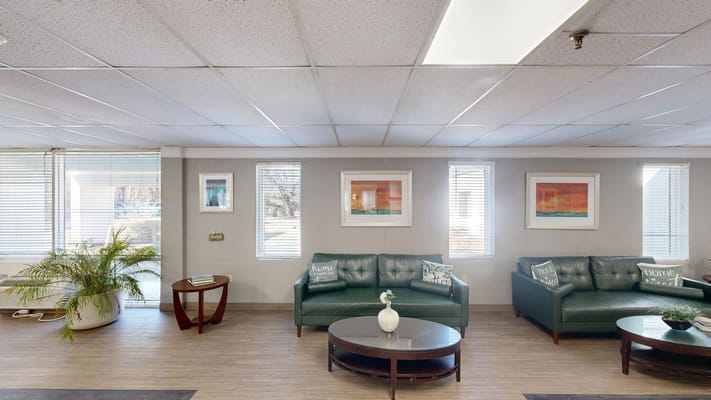 Interior view of a cozy lounge area with green sofas