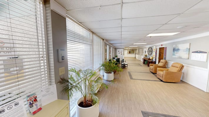 Bright interior hallway with seating and plants