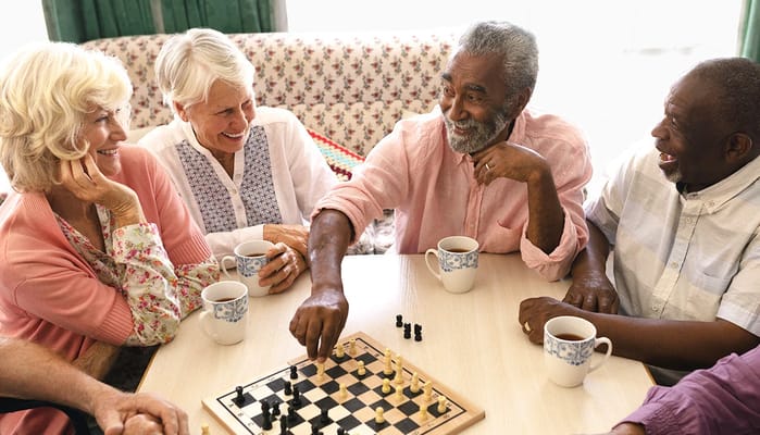 Residents enjoying a game of chess in a common area