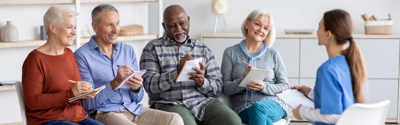 Residents participating in a group activity with staff