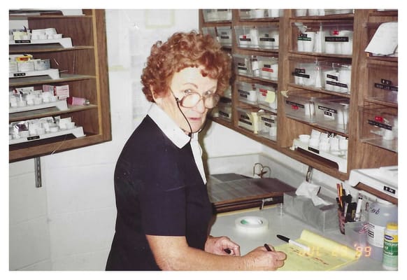 A staff member writing at a desk inside the facility