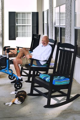 Resident enjoying time on the porch with a cat
