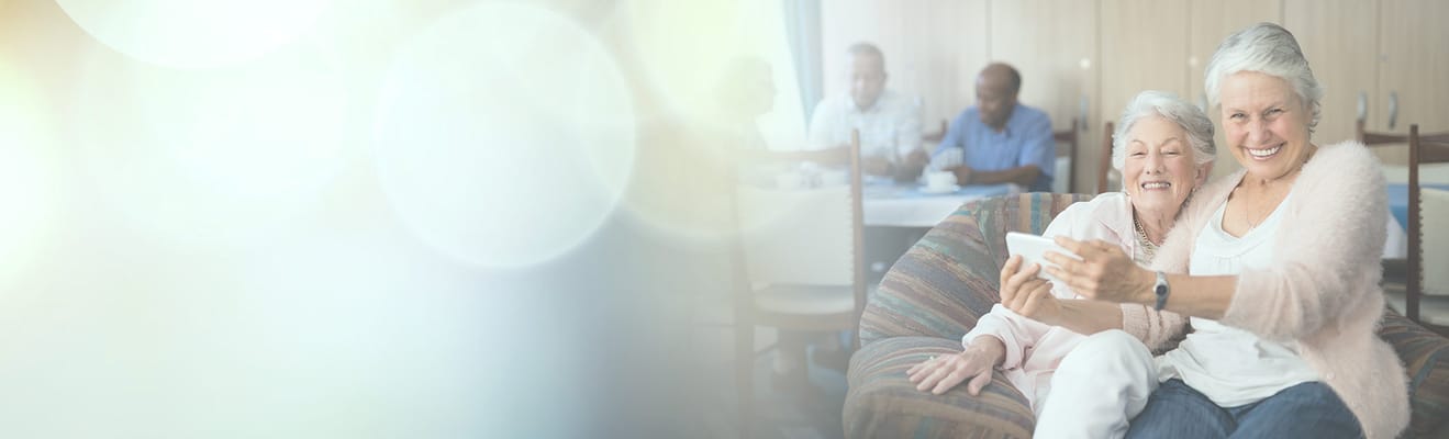 Two senior women enjoying a moment together in a cozy setting