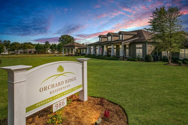 Exterior view of Orchard Ridge Residences at sunset