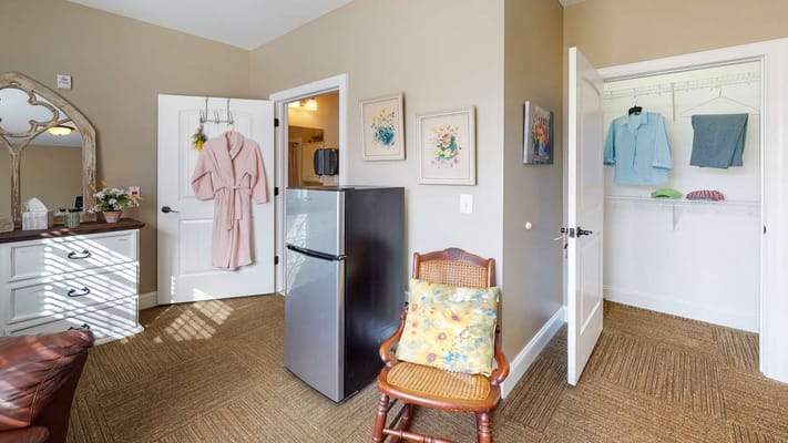Interior view of a private resident room with a closet